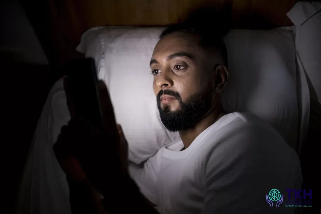 man checking his phone before sleeping branded, TheKnowHow UAE